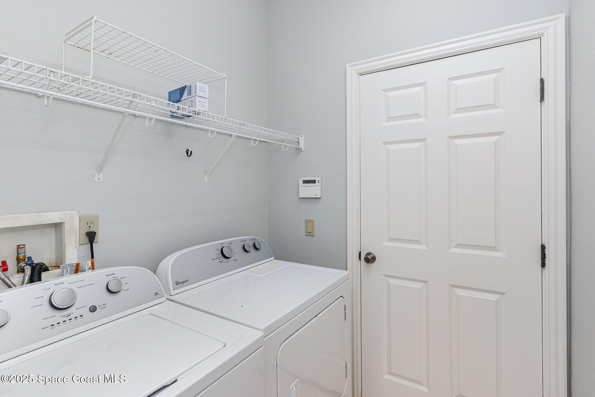609 Cedar Side Circle Northeast Palm Bay, FL 32905 - Photo 9 of 19 a utility room with dryer and washer