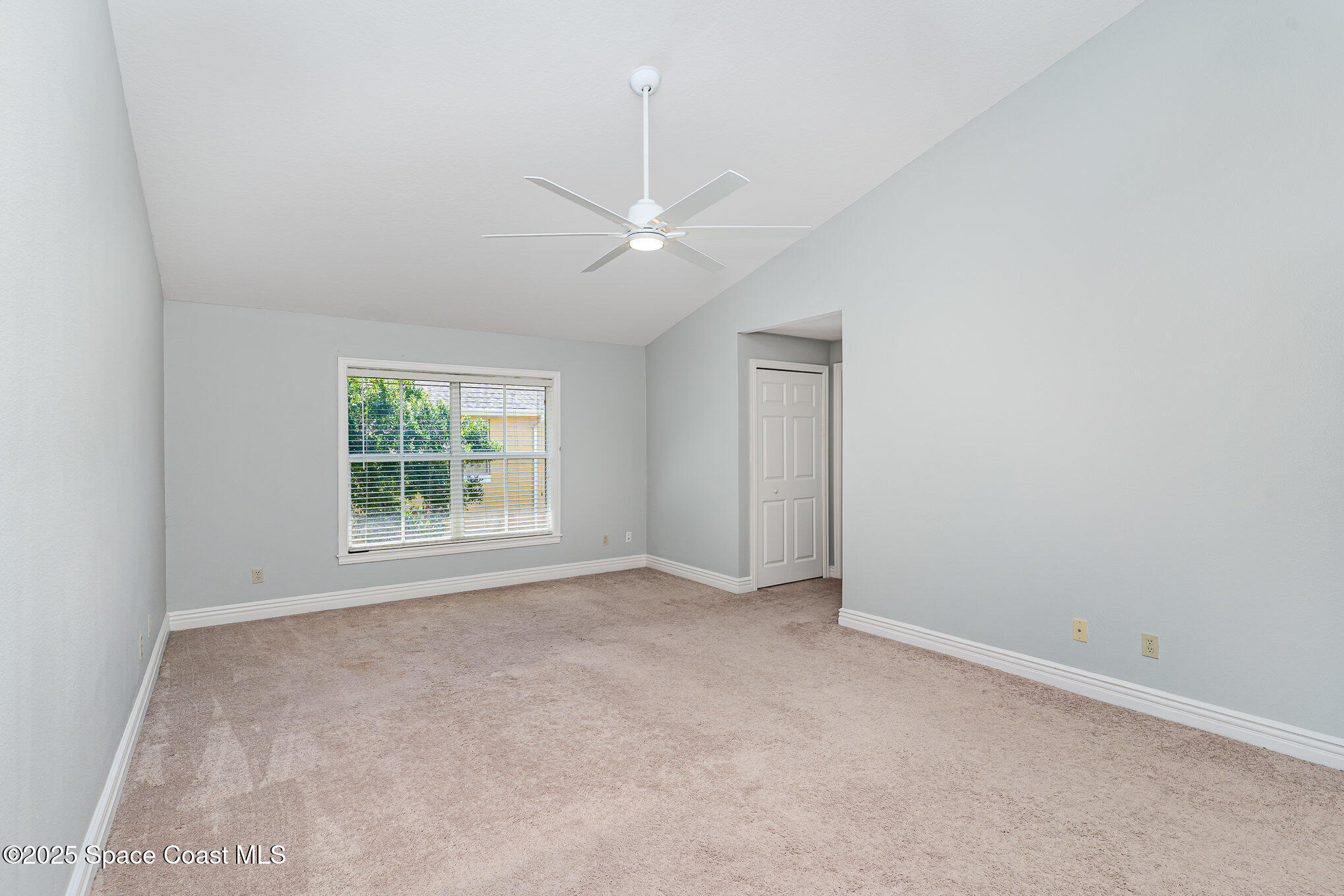 609 Cedar Side Circle Northeast Palm Bay, FL 32905 - Photo 10 of 19 an empty room with a ceiling fan and a window