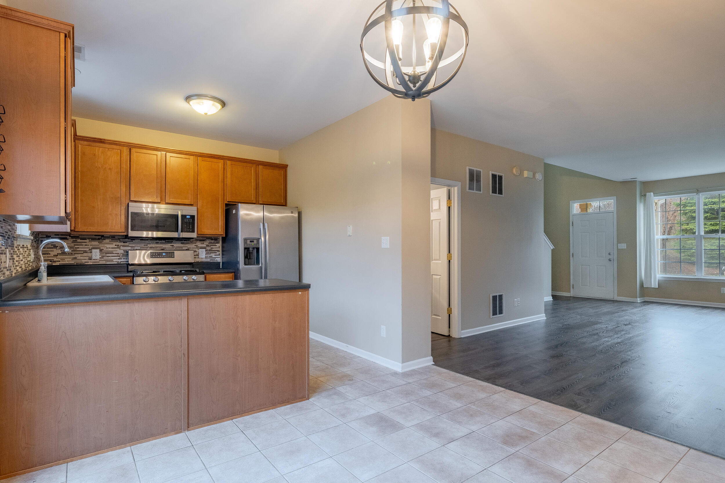 11742 Broadway Crown Point, IN 46307 - Photo 12 of 41 a view of kitchen with stainless steel appliances granite countertop a stove top oven a sink and a refrigerator