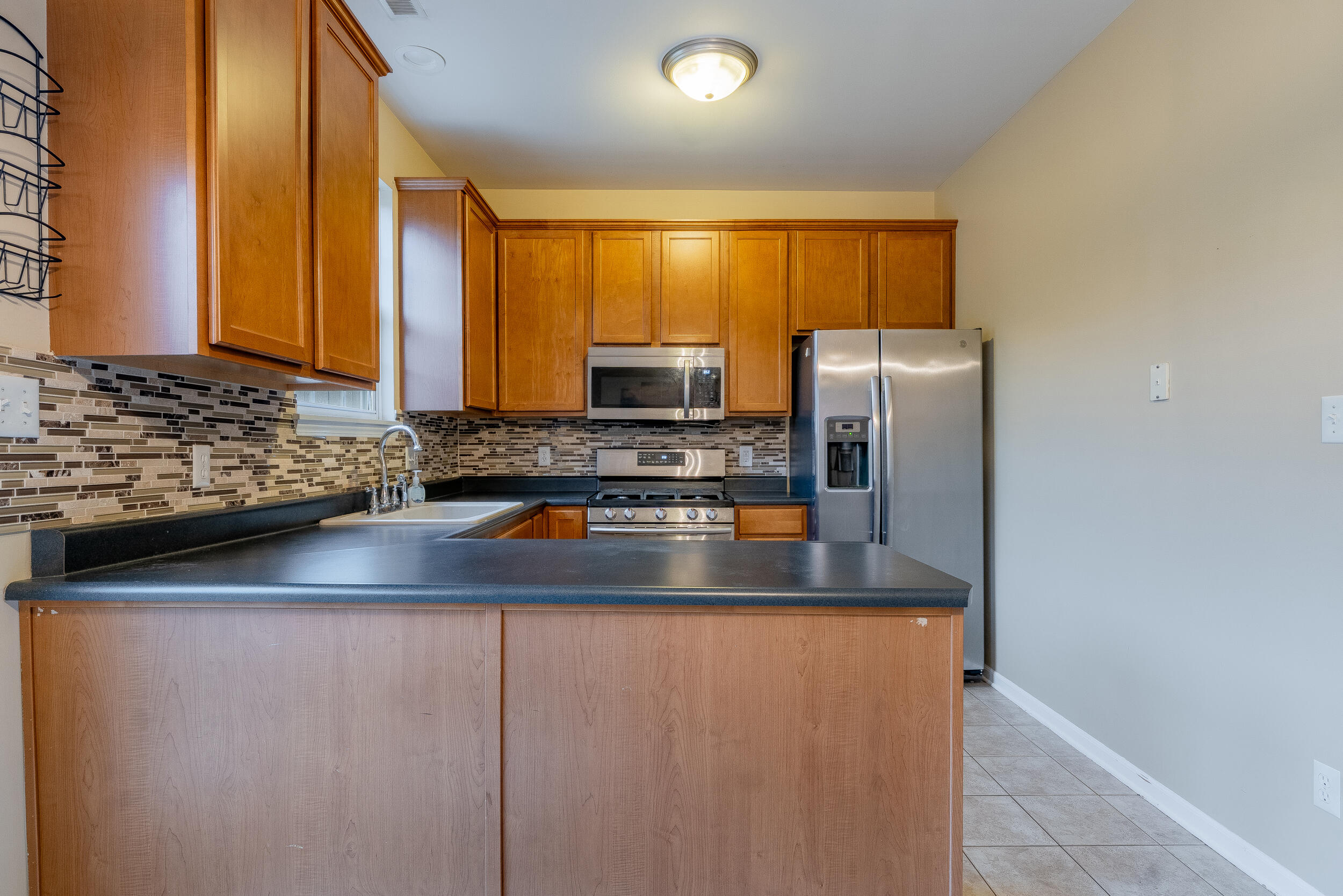 11742 Broadway Crown Point, IN 46307 - Photo 14 of 41 a kitchen with stainless steel appliances granite countertop a refrigerator and a sink