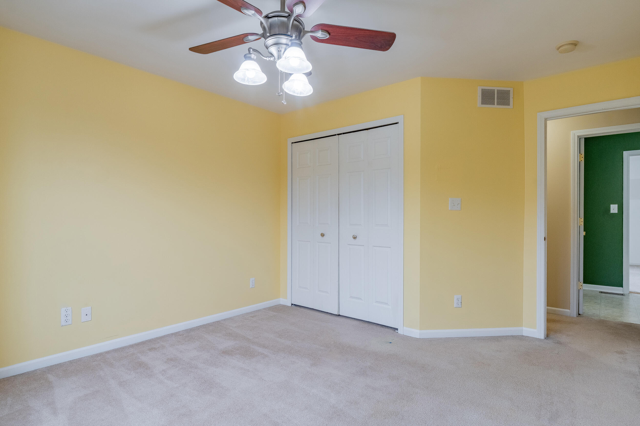 11742 Broadway Crown Point, IN 46307 - Photo 20 of 41 an empty room with a chandelier fan and a ceiling fan
