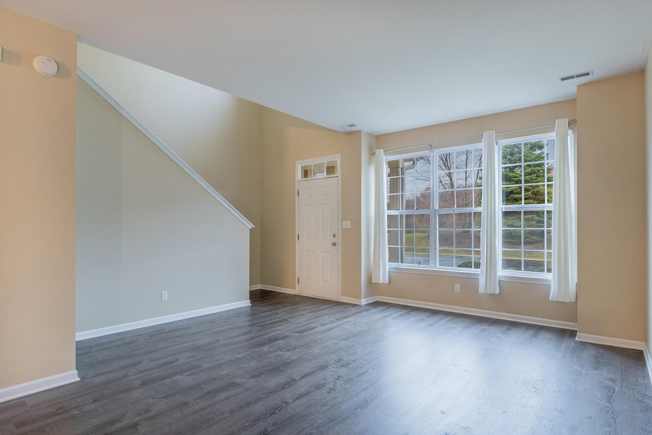 11742 Broadway Crown Point, IN 46307 - Photo 6 of 41 an empty room with wooden floor and windows