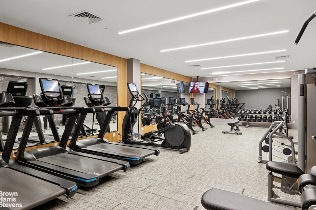 111 West 56th Street, Unit 38L Manhattan, NY 10019 - Photo 11 of 12 a view of a room with gym equipment