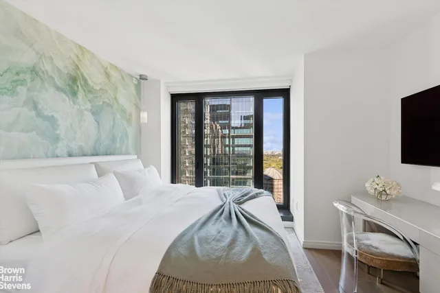 a living room with furniture a rug and kitchen view