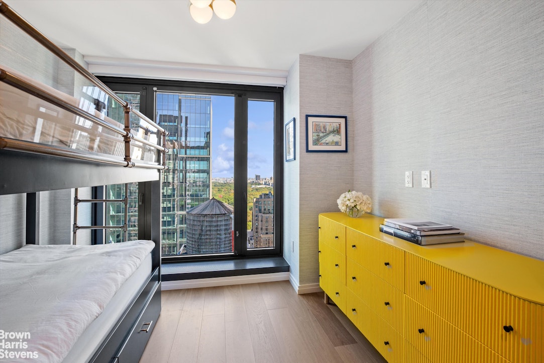 111 West 56th Street, Unit 38L Manhattan, NY 10019 - Photo 7 of 12 a bed room with a bed and a window