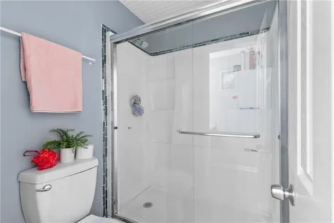 a bathroom with a shower toilet and a shower