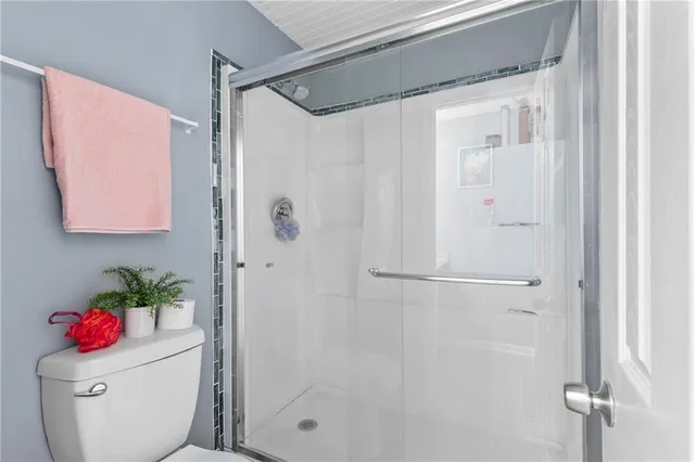 a bathroom with a shower toilet and a shower