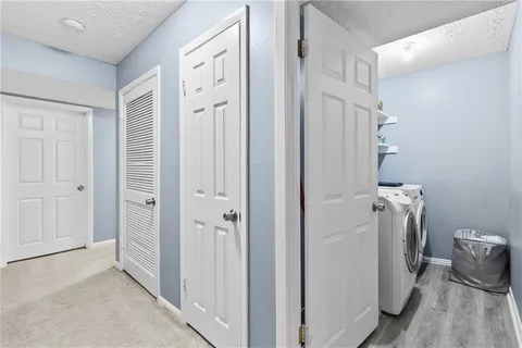 a view of a livingroom with furniture and a door