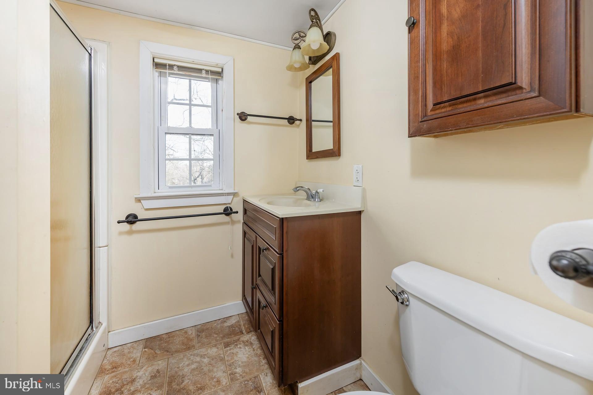 41 Hackett Road Woodstown, NJ 08098 - Photo 17 of 67 a bathroom with a sink toilet and window