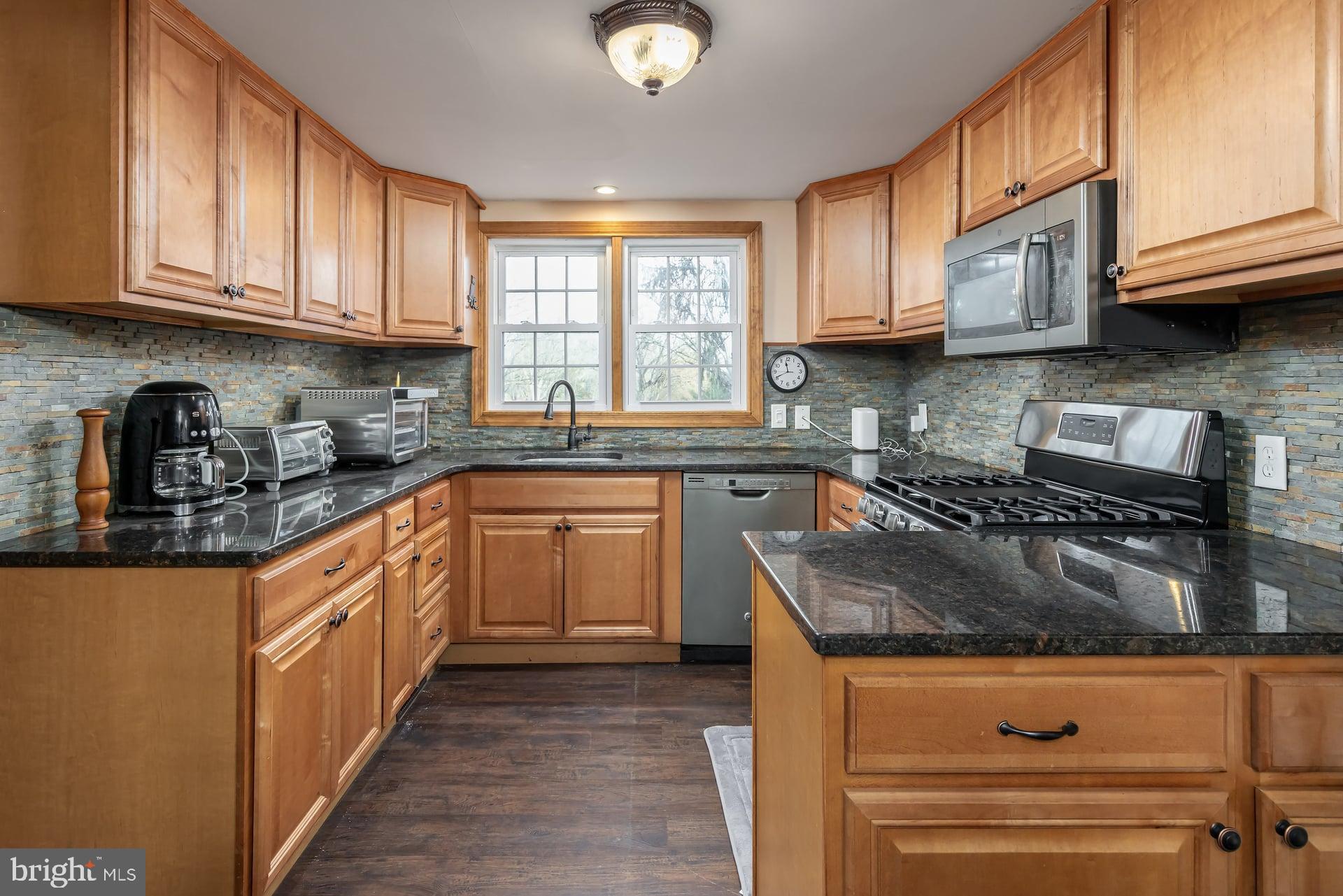 41 Hackett Road Woodstown, NJ 08098 - Photo 10 of 67 a kitchen with stainless steel appliances granite countertop a stove sink and cabinets