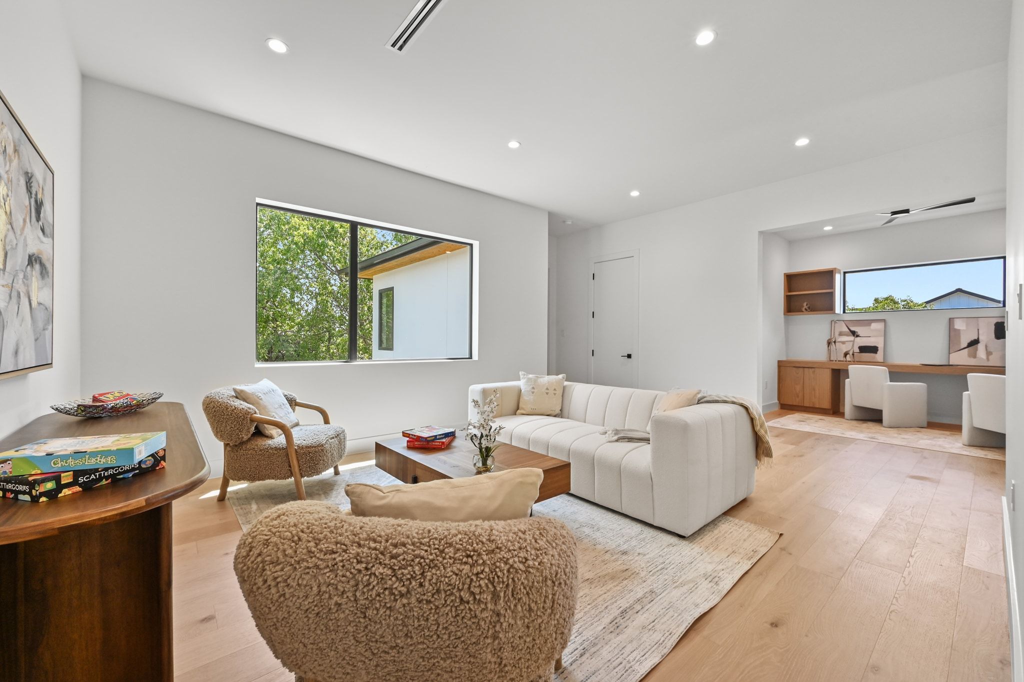 1503 Barn Swallow Drive Austin, TX 78746 - Photo 25 of 40 a living room with furniture two large window and a wooden floor
