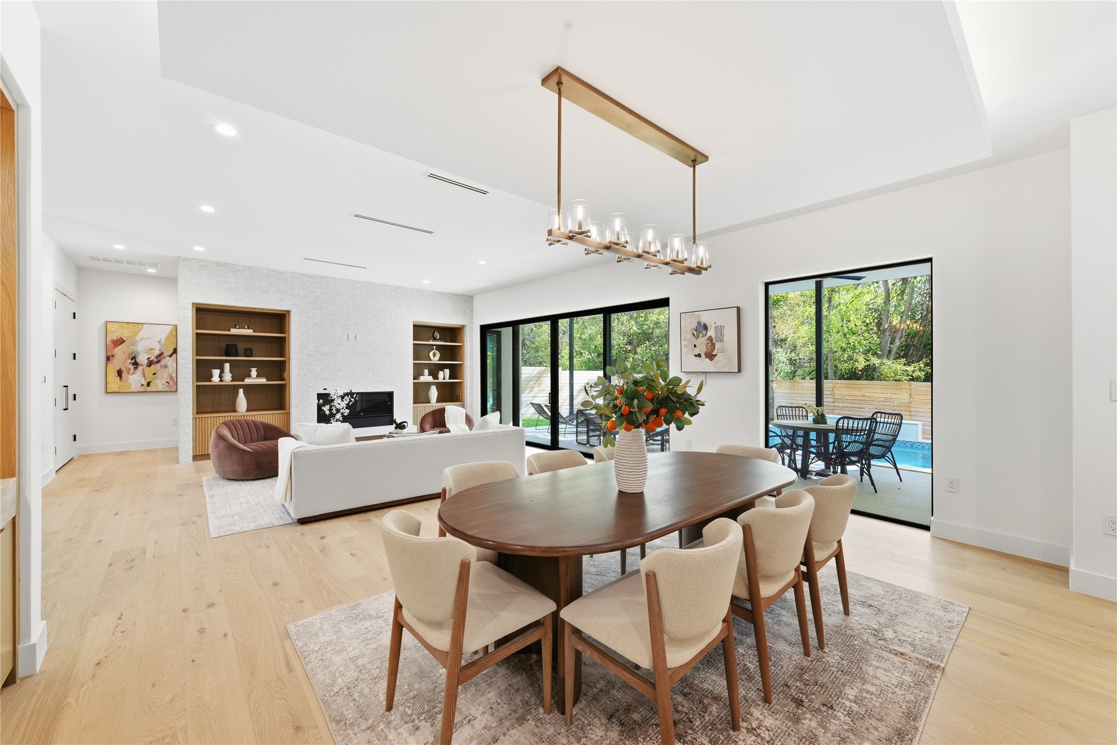 1503 Barn Swallow Drive Austin, TX 78746 - Photo 3 of 40 a dining room with furniture a chandelier and wooden floor