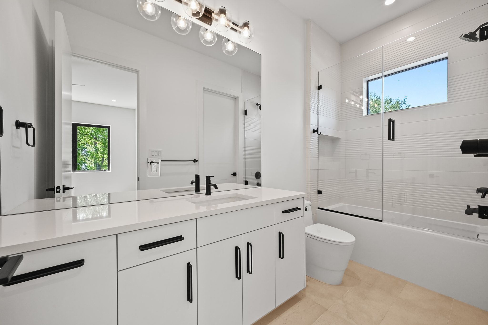 1503 Barn Swallow Drive Austin, TX 78746 - Photo 33 of 40 a bathroom with a double vanity sink toilet mirror and bathtub