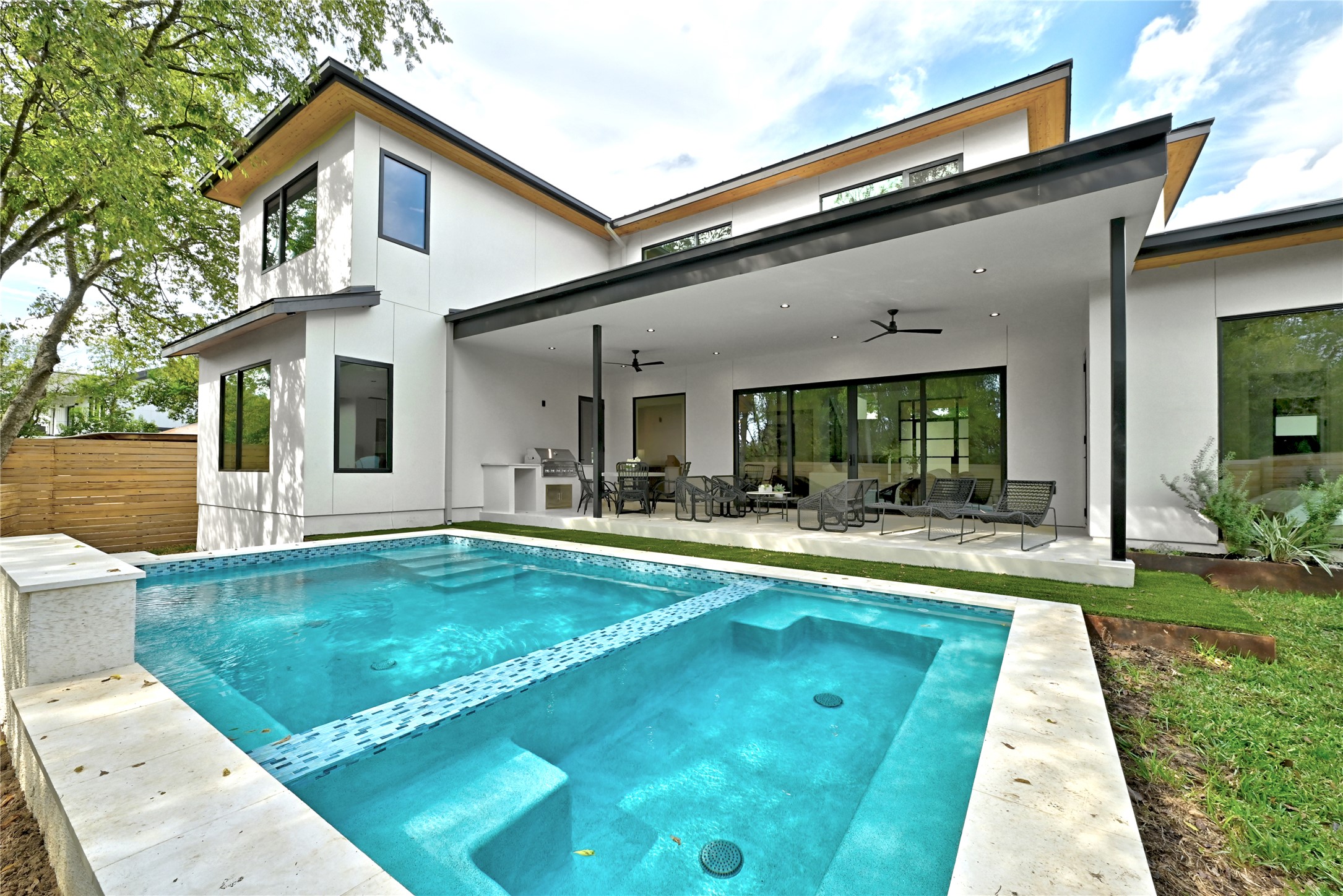 1503 Barn Swallow Drive Austin, TX 78746 - Photo 35 of 40 a view of white house with a yard patio and swimming pool