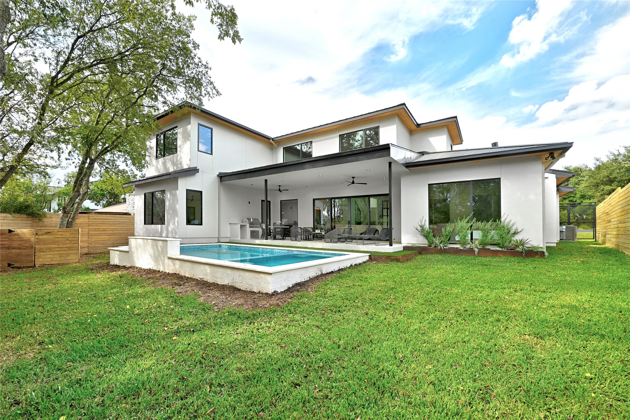 1503 Barn Swallow Drive Austin, TX 78746 - Photo 39 of 40 a front view of a house with a garden and patio