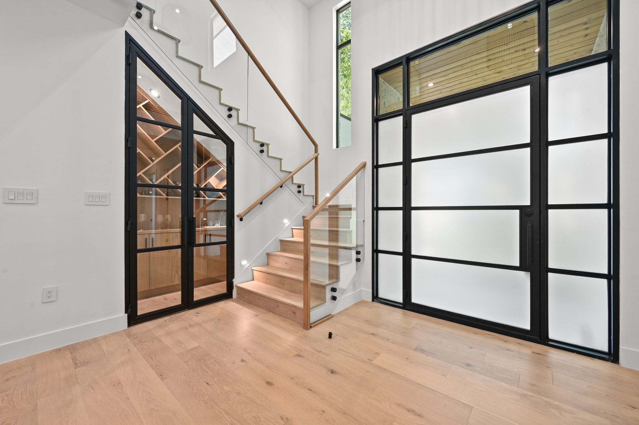 1503 Barn Swallow Drive Austin, TX 78746 - Photo 6 of 40 a view of staircase with wooden floor and window