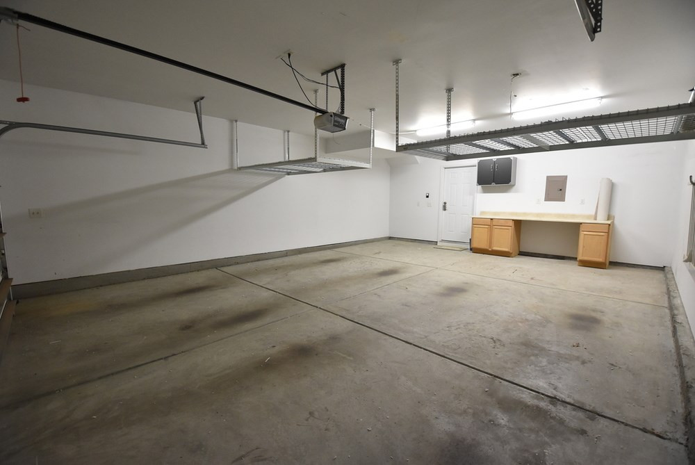 5809 Hourglass Court Raleigh, NC 27612 - Photo 24 of 30 1-owner Avalon model w/oversize 2-car SUV Garage (w/2 lg ceiling storage racks and cabinets/workbench). Garage