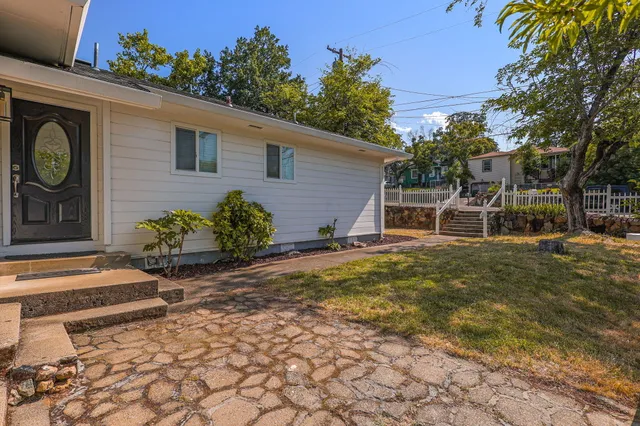 a backyard of a house with table and chairs