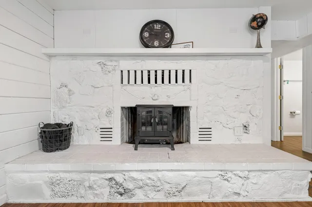 a living room with a fireplace and a rug