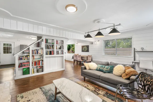 a living room with furniture and a book shelf