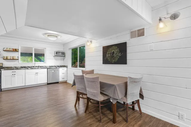 a kitchen with a sink cabinets and wooden floor