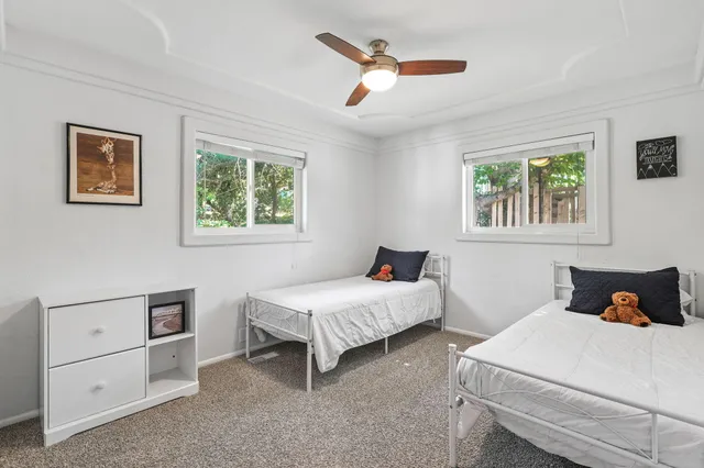 a bedroom with two beds and a window