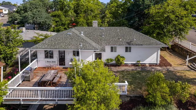 a front view of house with yard and trees around