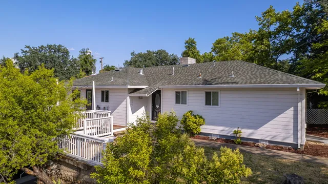 a aerial view of a house with a yard and potted plants