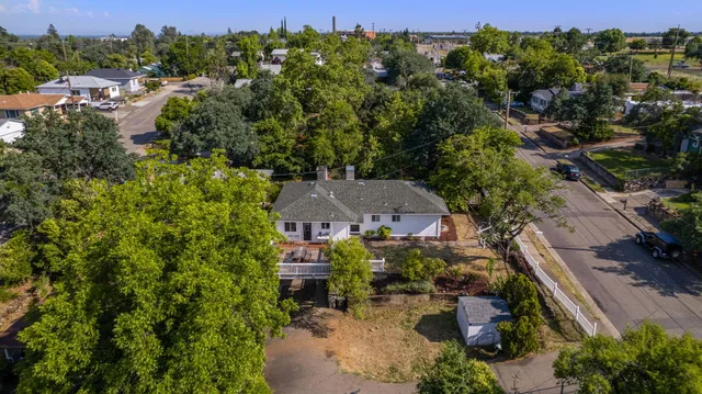 an aerial view of a house with garden space and street view