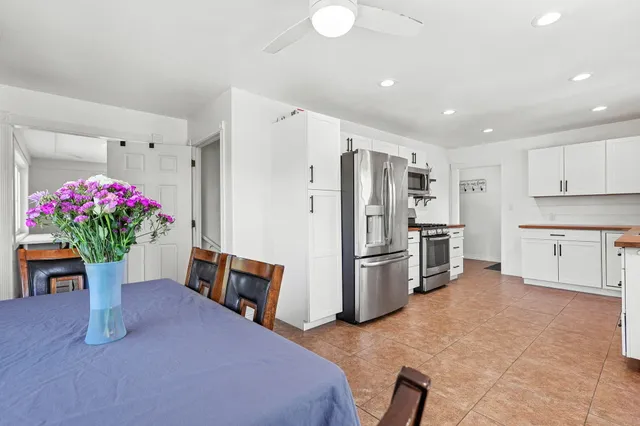 a kitchen with refrigerator and cabinets