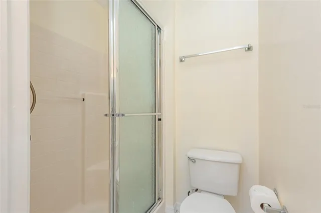 a bathroom with a toilet and a shower