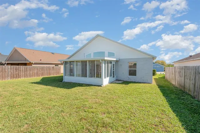 a view of a house with backyard and garden