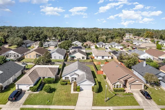an aerial view of residential houses with outdoor space