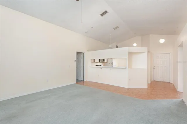 a view of kitchen and hall with wooden floor