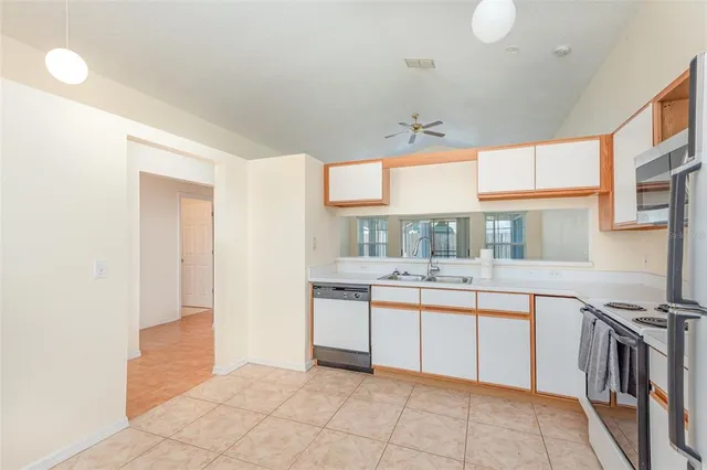 a kitchen with stainless steel appliances granite countertop a sink and cabinets