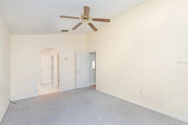 a view of a room with a ceiling fan