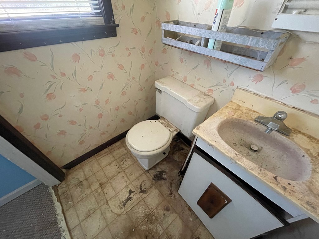 1135 Casteel Road Powder Springs, GA 30127 - Photo 32 of 45 a bathroom with a granite countertop sink toilet and a mirror