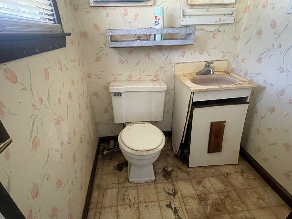 1135 Casteel Road Powder Springs, GA 30127 - Photo 33 of 45 a bathroom with a toilet and a sink