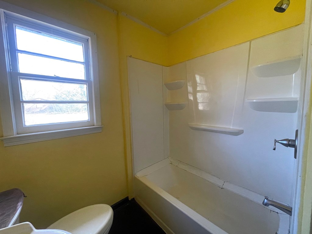 1135 Casteel Road Powder Springs, GA 30127 - Photo 40 of 45 a bathroom with a bathtub and window