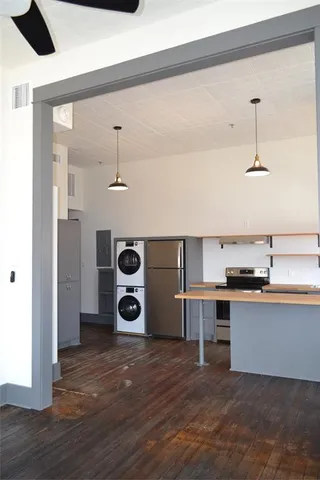 a kitchen with stainless steel appliances granite countertop a sink and wooden floor