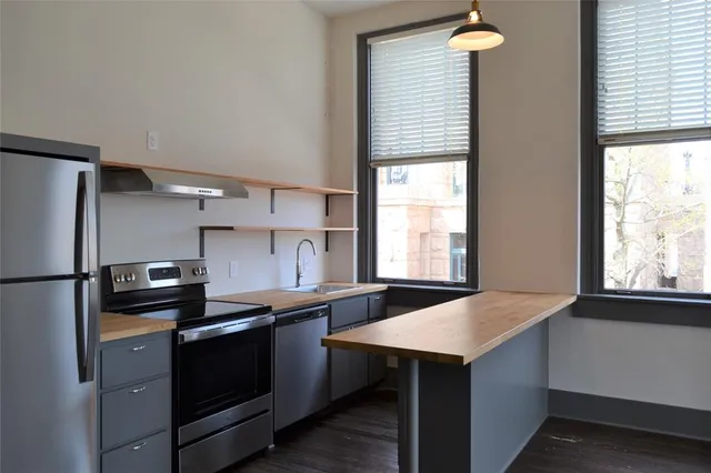 a kitchen with a sink appliances and cabinets