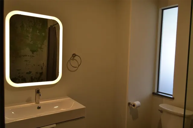 a bathroom with a shower and a sink