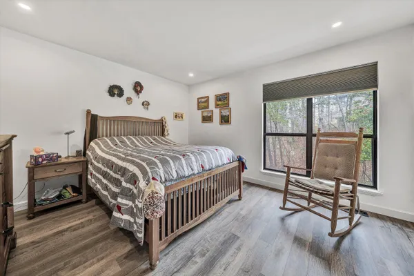 a bedroom with a bed and a tv on the table