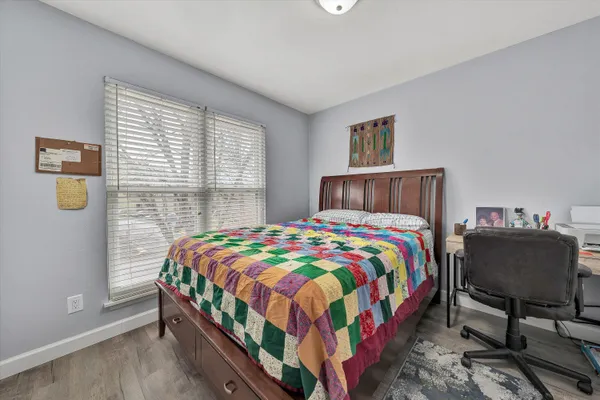a bedroom with a bed and chair