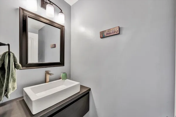 a bathroom with a sink vanity and a mirror