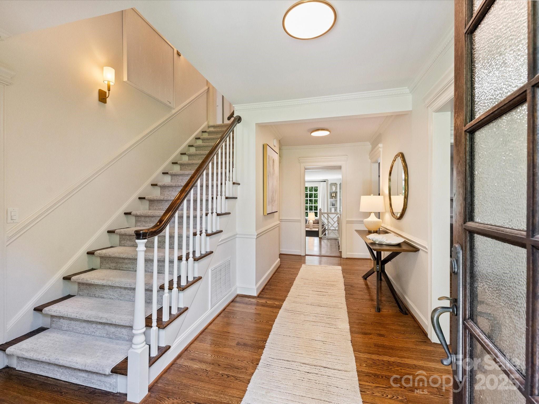 2919 Wickersham Road Charlotte, NC 28211 - Photo 3 of 30 a view of a hallway with wooden floor and staircase