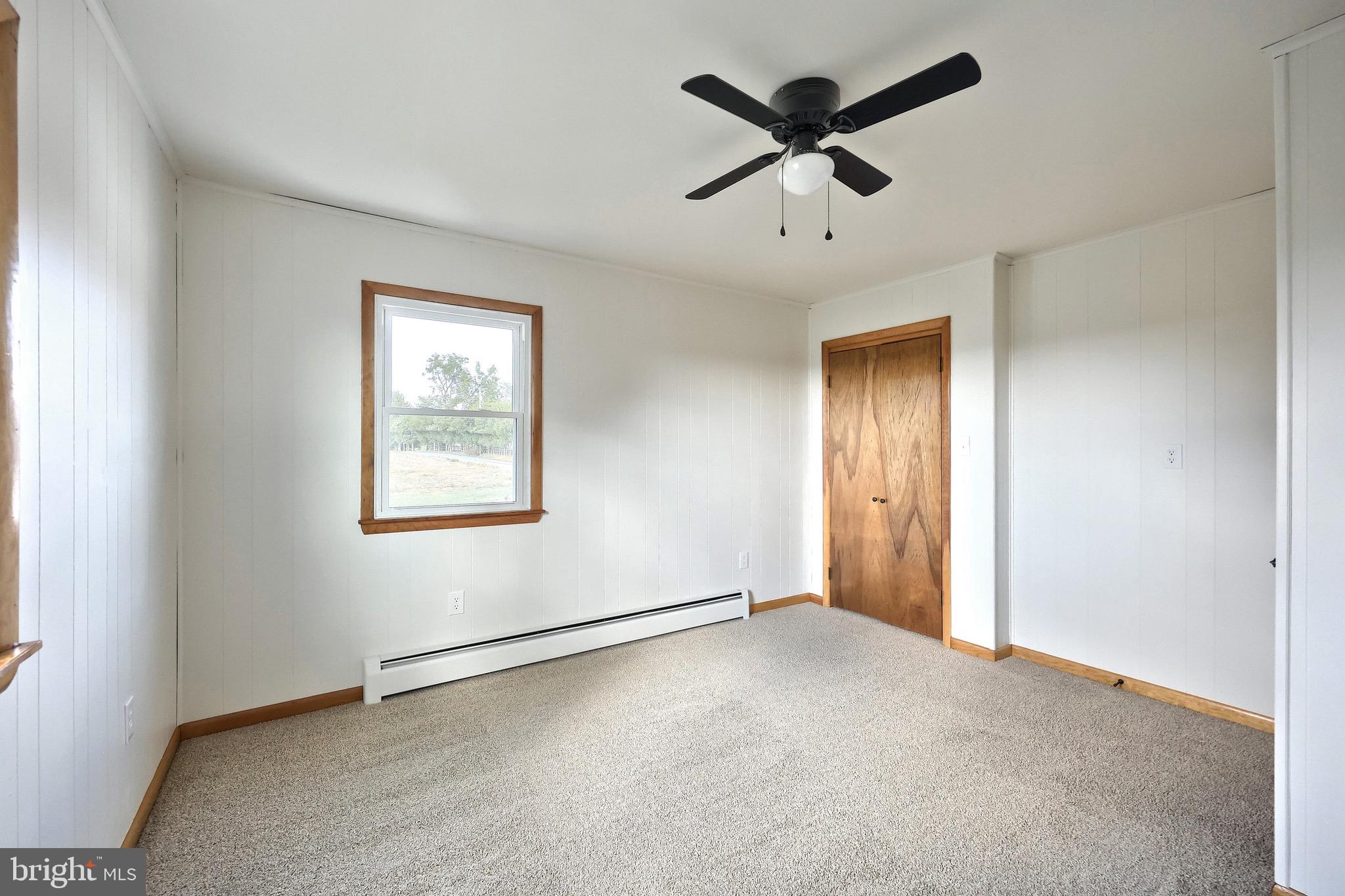 1825 White Hall Road Littlestown, PA 17340 - Photo 47 of 89 an empty room with a ceiling fan and window