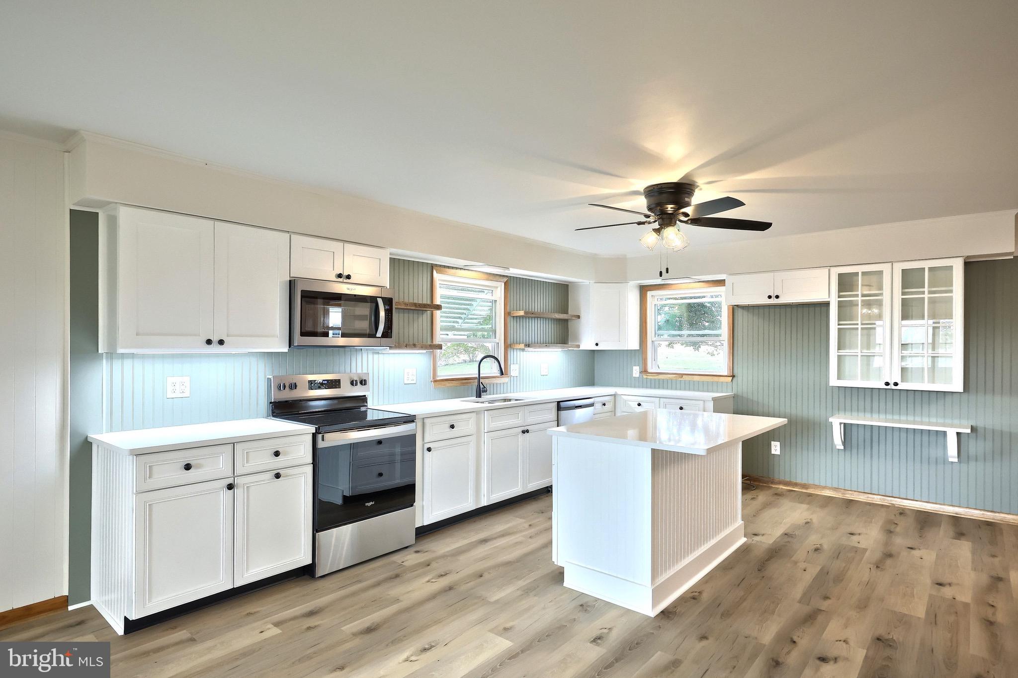 1825 White Hall Road Littlestown, PA 17340 - Photo 60 of 89 a kitchen with stainless steel appliances a sink stove and cabinets