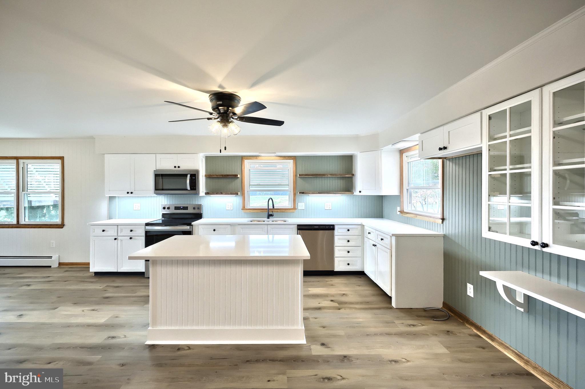 1825 White Hall Road Littlestown, PA 17340 - Photo 61 of 89 a kitchen with stainless steel appliances kitchen island granite countertop a sink stove and refrigerator