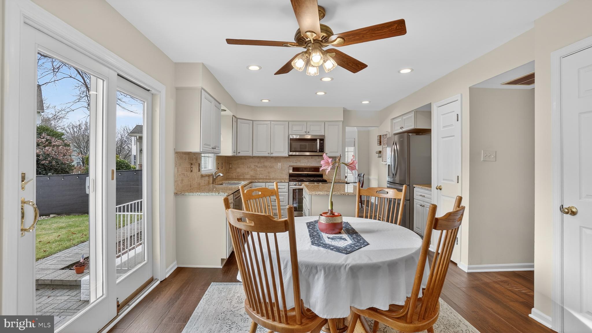 2709 Bains Court Crofton, MD 21114 - Photo 15 of 63 a kitchen with stainless steel appliances granite countertop a dining table chairs and refrigerator